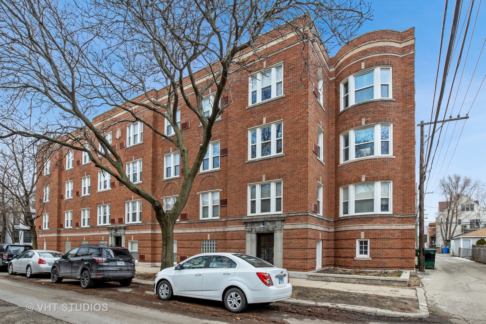 a front view of a residential apartment building with a yard