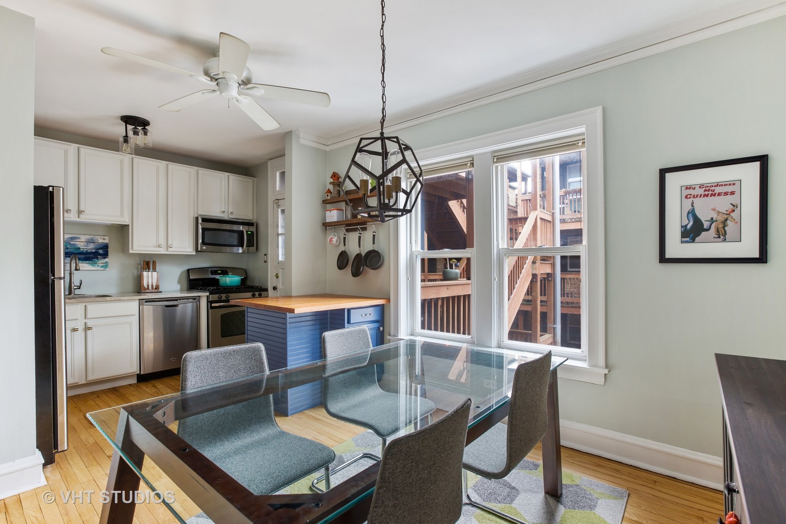 1946 West Patterson Avenue, Unit 2 Chicago, IL 60613 - Photo 8 of 13 a kitchen with granite countertop a stove a sink a dining table and chairs