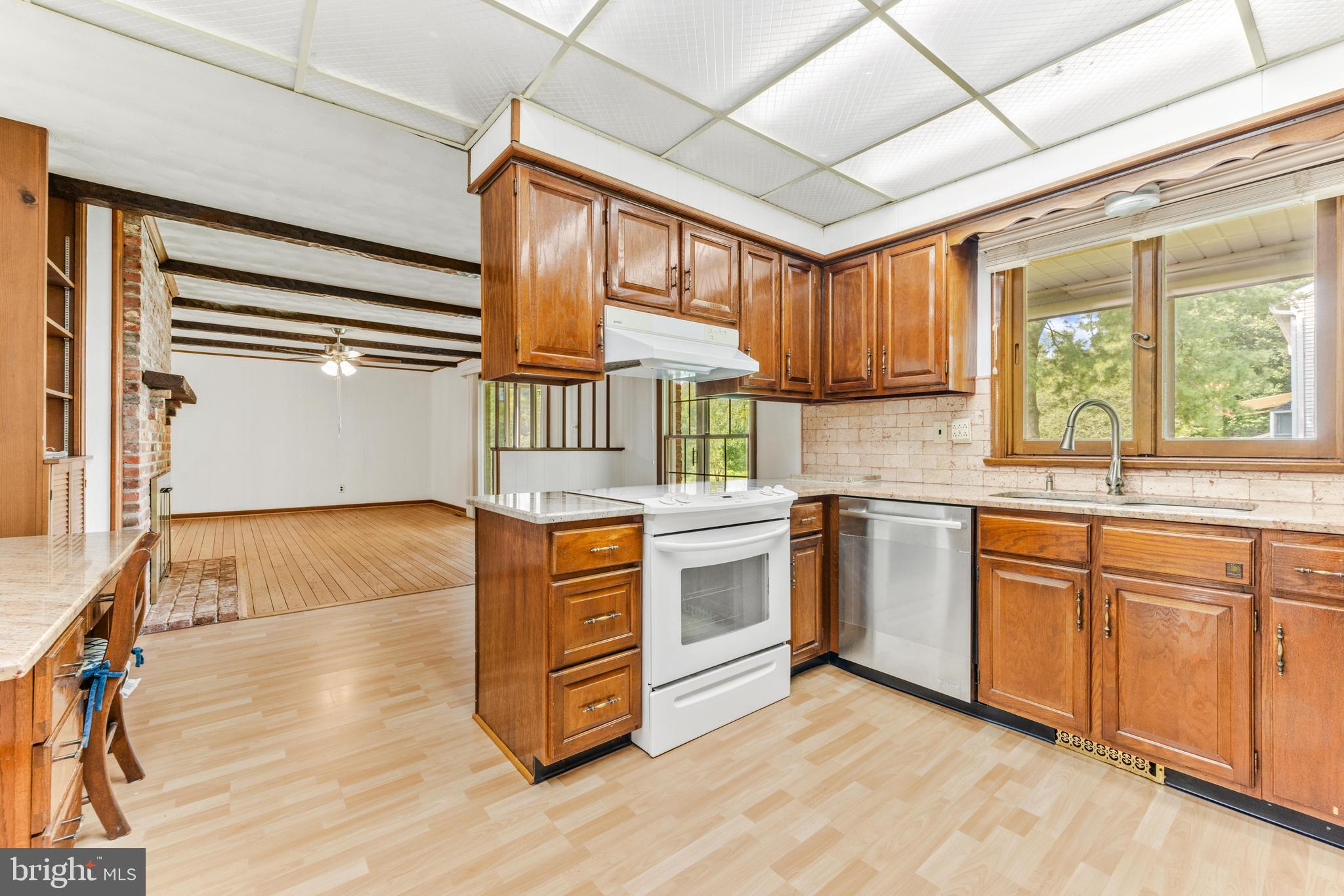 4218 Southfield Road Ellicott City, MD 21042 - Photo 15 of 59 a kitchen with stainless steel appliances granite countertop a stove a sink and a refrigerator