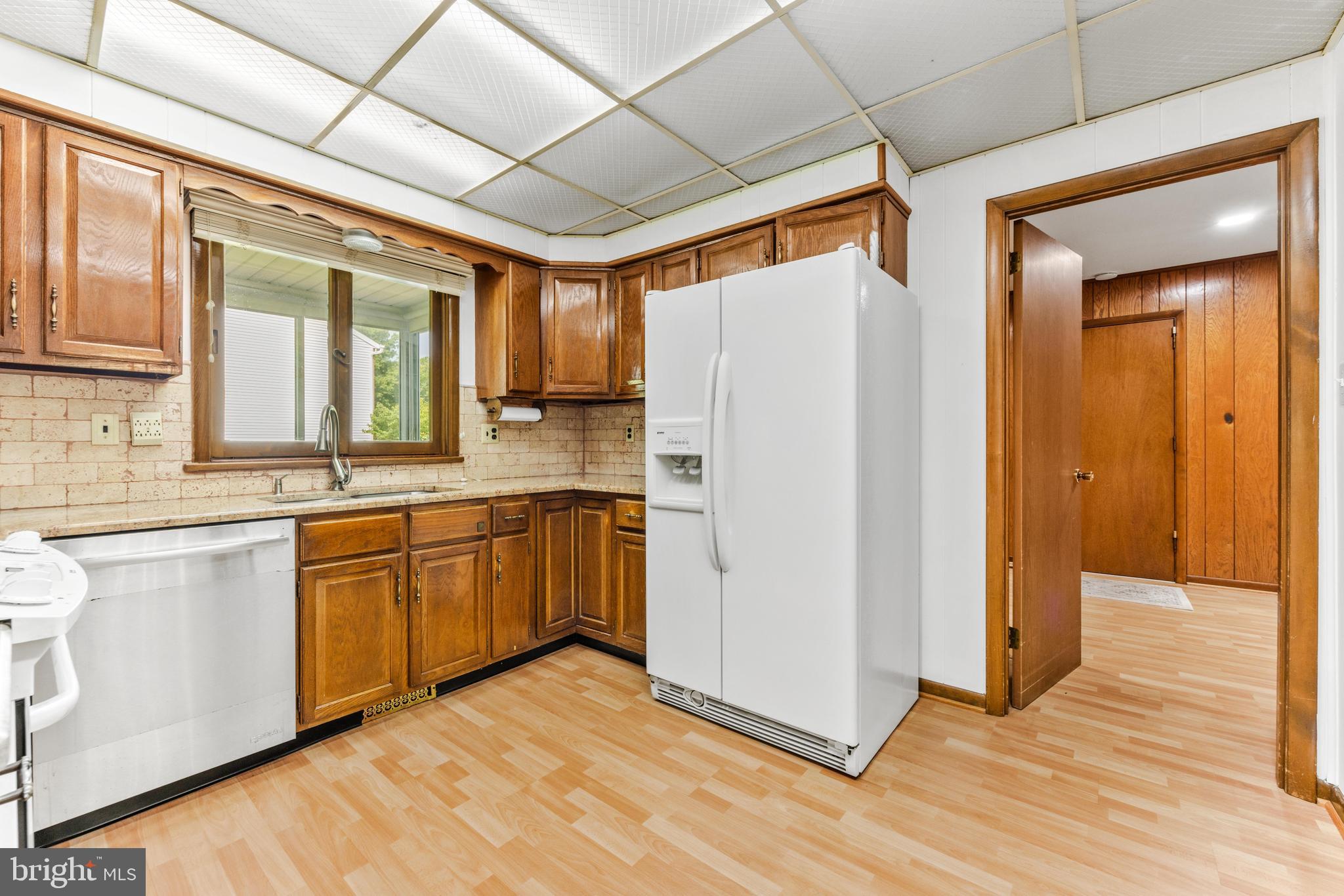 4218 Southfield Road Ellicott City, MD 21042 - Photo 18 of 59 a kitchen with stainless steel appliances granite countertop a refrigerator a sink and dishwasher with wooden floor