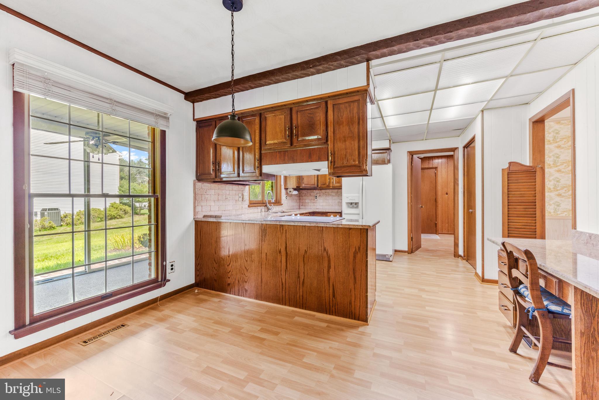 4218 Southfield Road Ellicott City, MD 21042 - Photo 21 of 59 a kitchen with kitchen island a large window cabinets a sink and stainless steel appliances