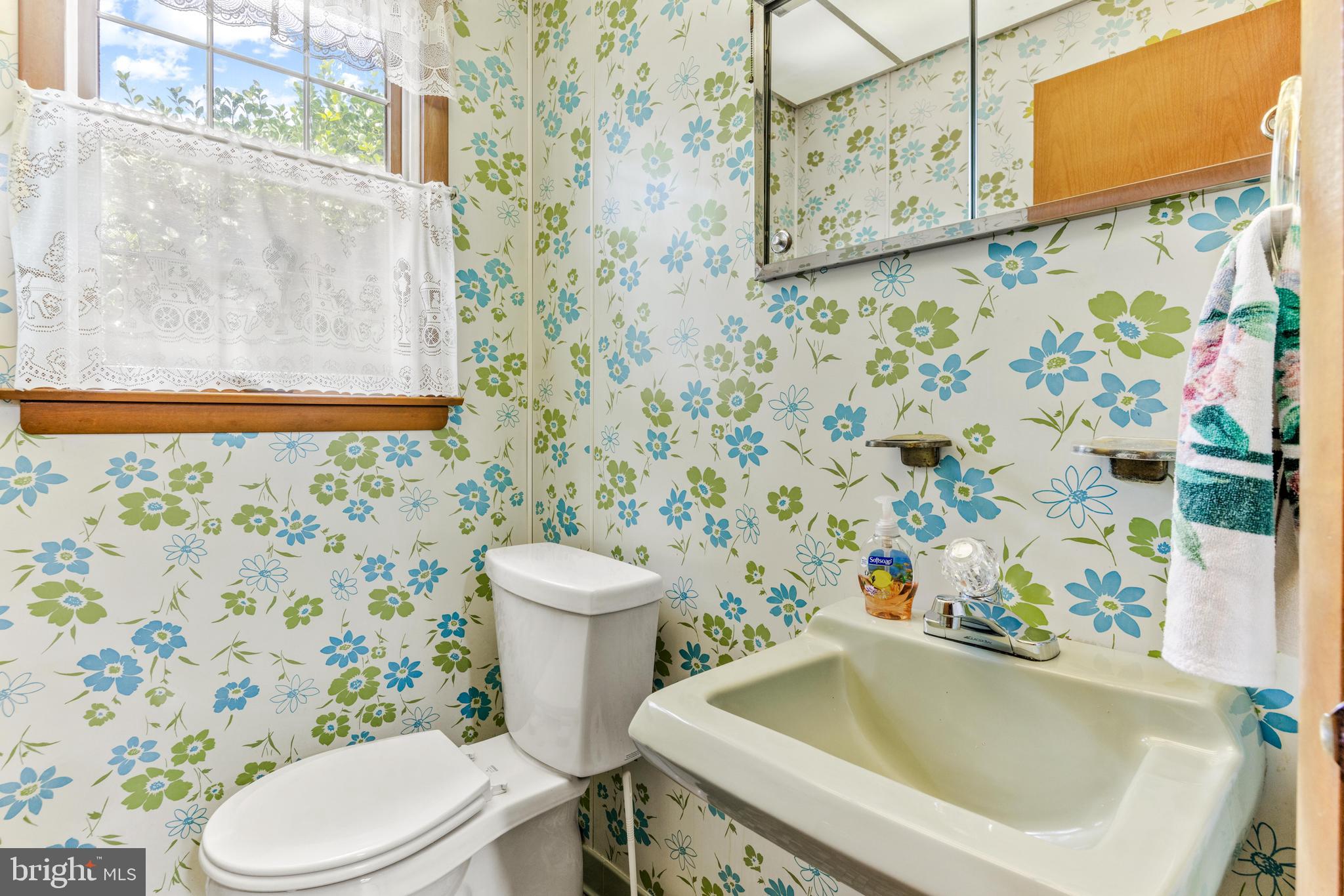 4218 Southfield Road Ellicott City, MD 21042 - Photo 26 of 59 a white toilet sitting next to a shower curtain