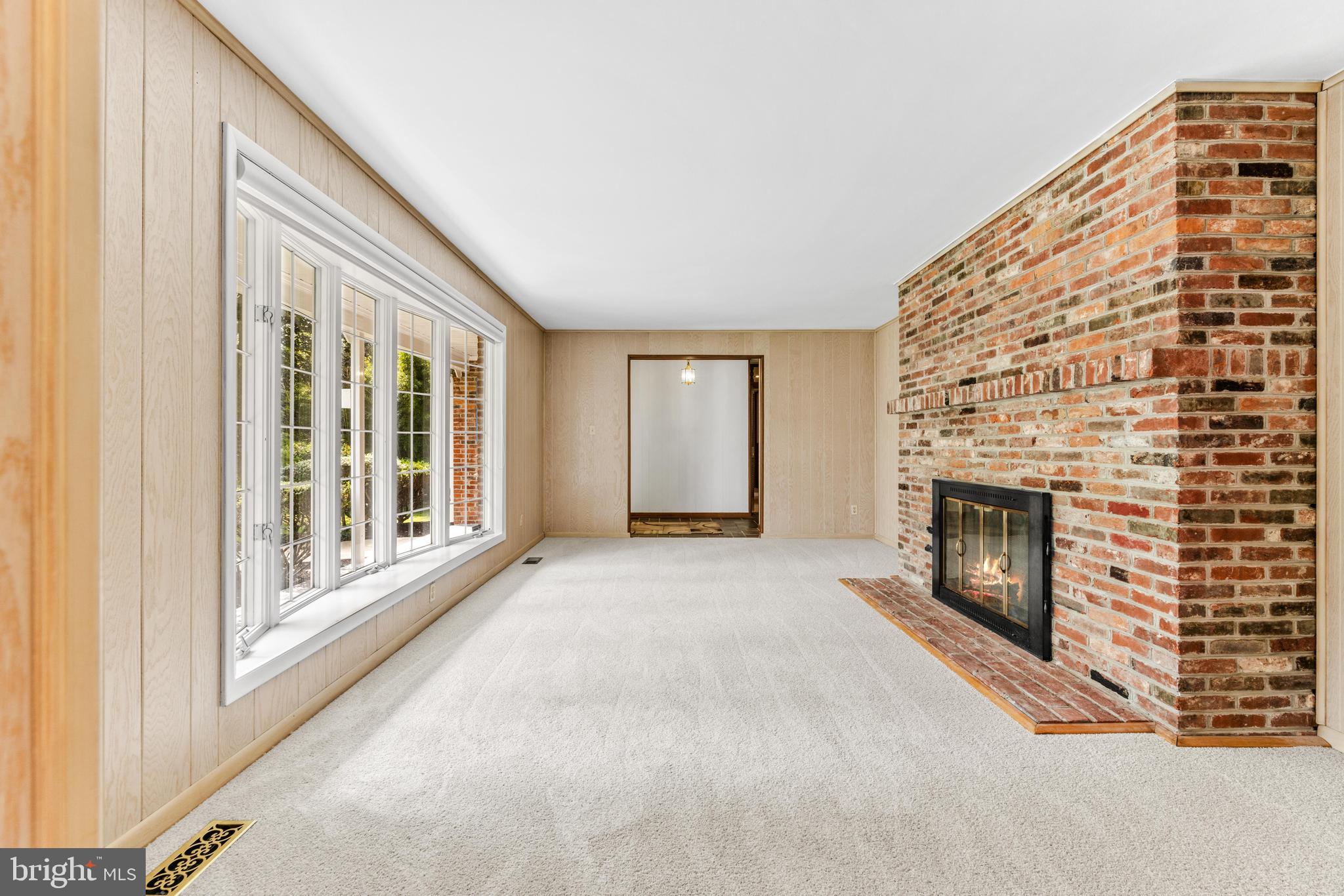 4218 Southfield Road Ellicott City, MD 21042 - Photo 3 of 59 a view of an empty room with a fireplace and a window