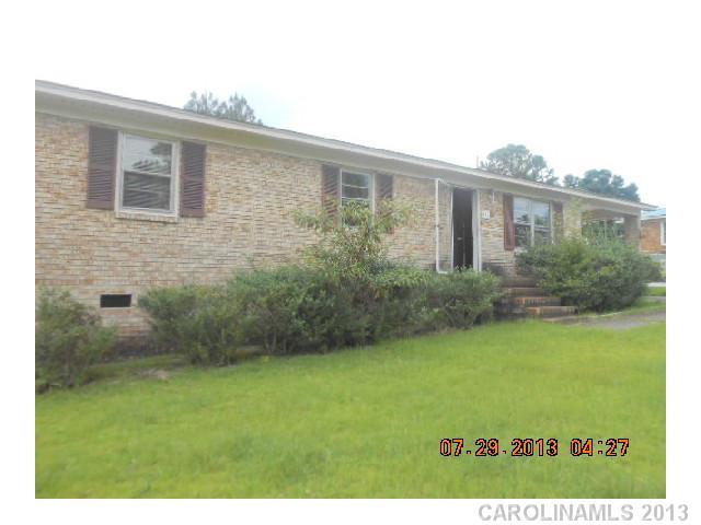 191 Lakeview Trail Rockingham, NC 28379 - Photo 1 of 1 a view of a backyard with plants and large trees