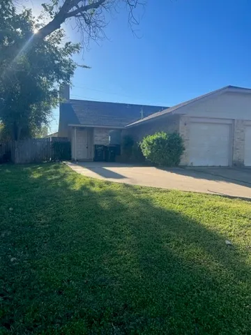 a view of a yard with a house in the background