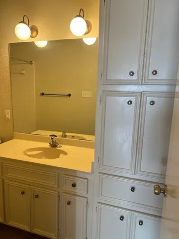 a bathroom with a sink and vanity