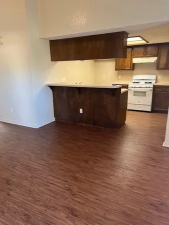 a kitchen with stainless steel appliances a stove and cabinets