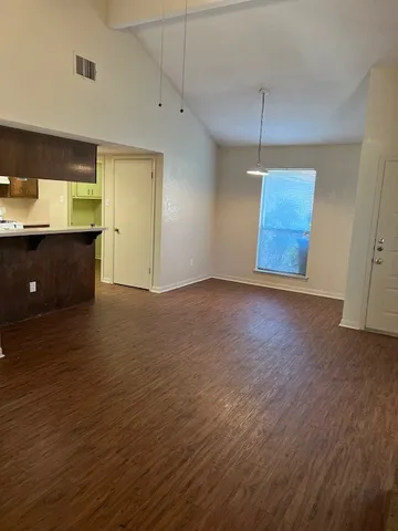 a view of a kitchen with a sink and a window