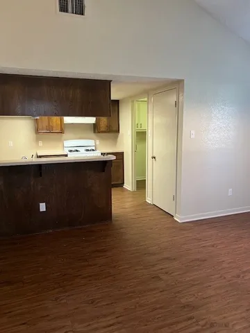 a view of kitchen with stainless steel appliances granite countertop a sink and a stove