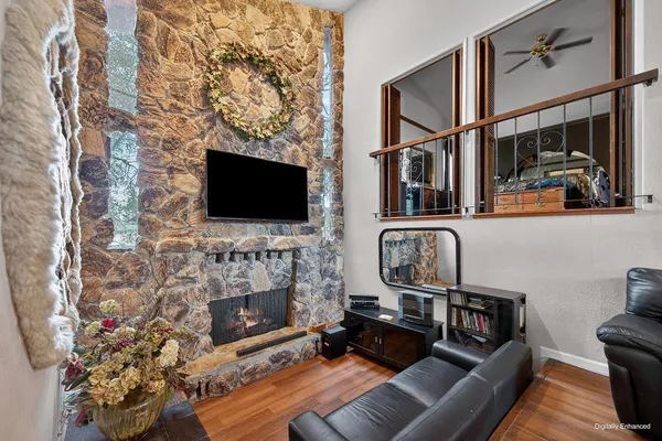a living room with fireplace furniture and a flat screen tv