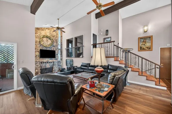 a dining room with furniture a flat screen tv and a window