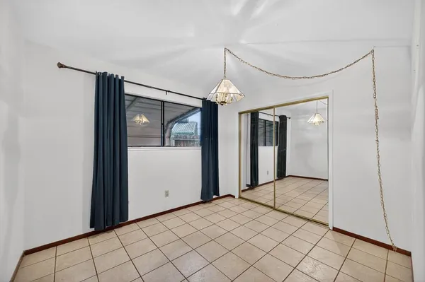 a view of a hallway with wooden floor and chandelier