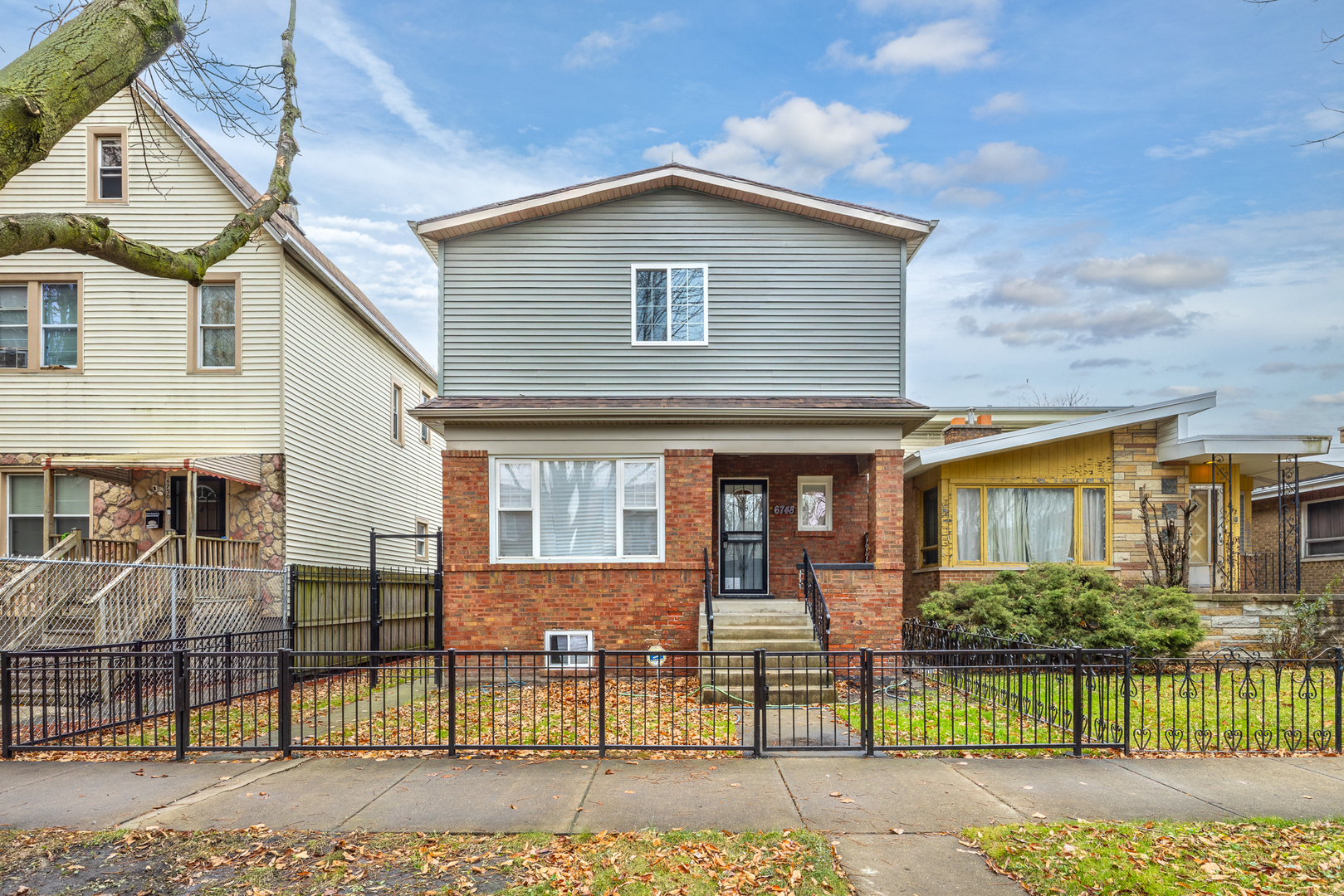 a front view of a house with a garden