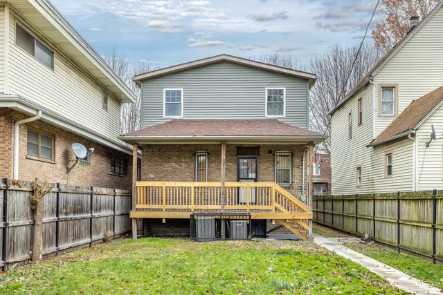 a view of house with a yard outdoor seating and deck
