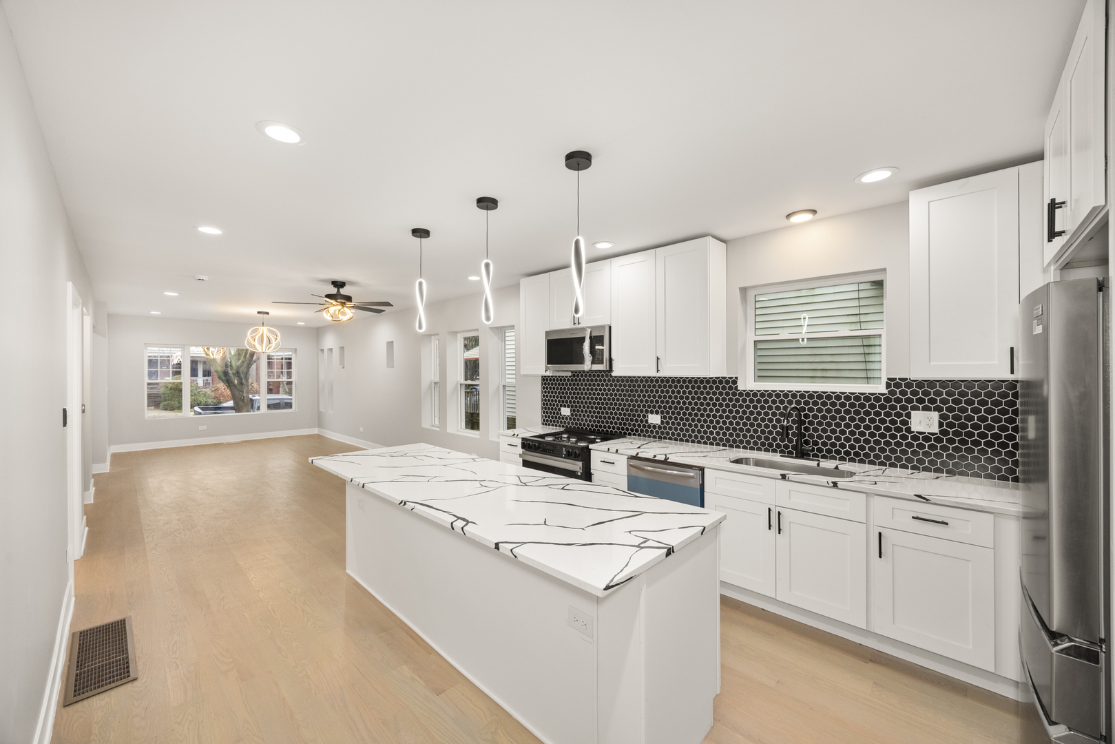 6748 South Indiana Avenue Chicago, IL 60637 - Photo 5 of 19 a kitchen with stainless steel appliances kitchen island granite countertop a sink and cabinets