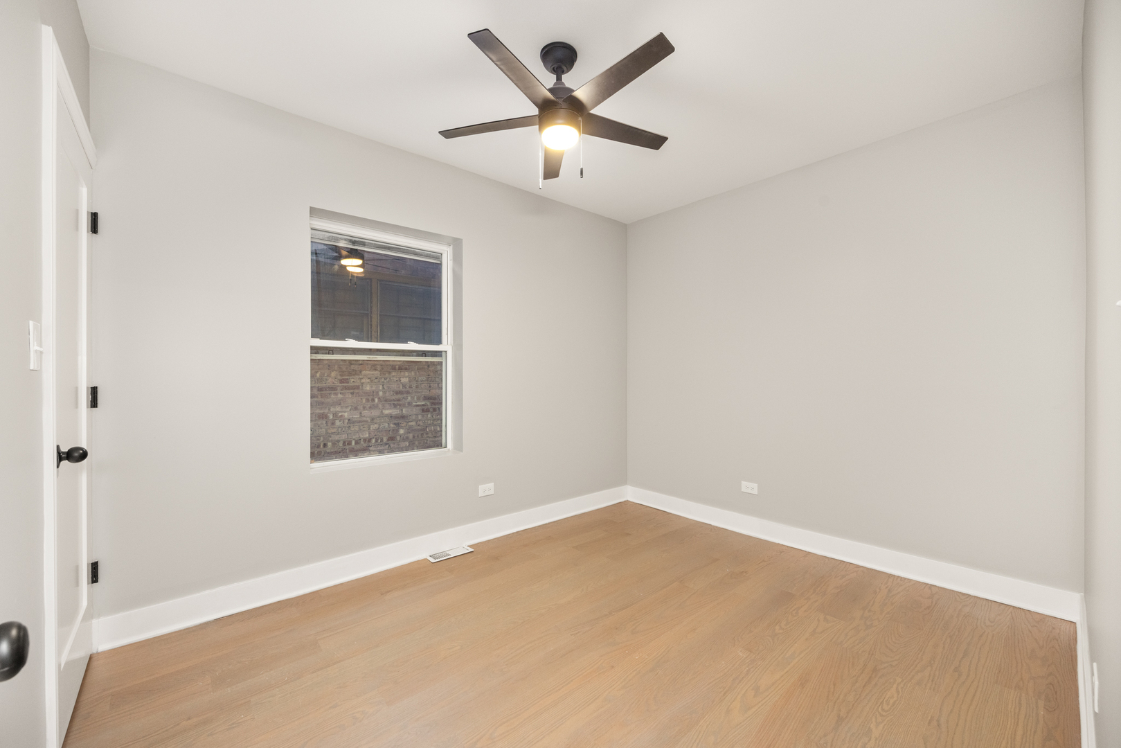 6748 South Indiana Avenue Chicago, IL 60637 - Photo 6 of 19 an empty room with a window and a fan