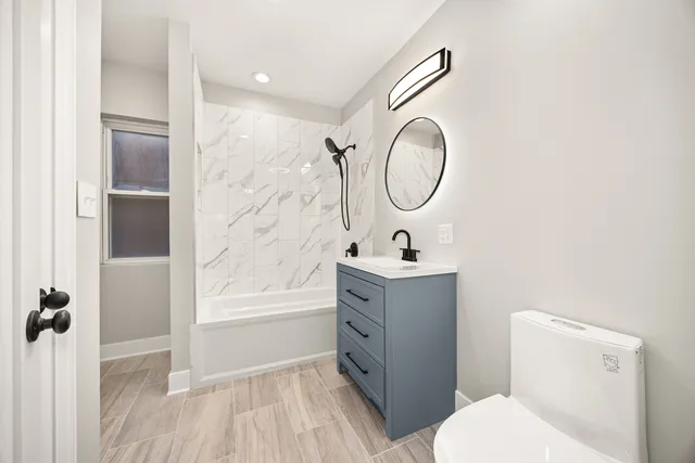 a bathroom with a sink a toilet and a mirror