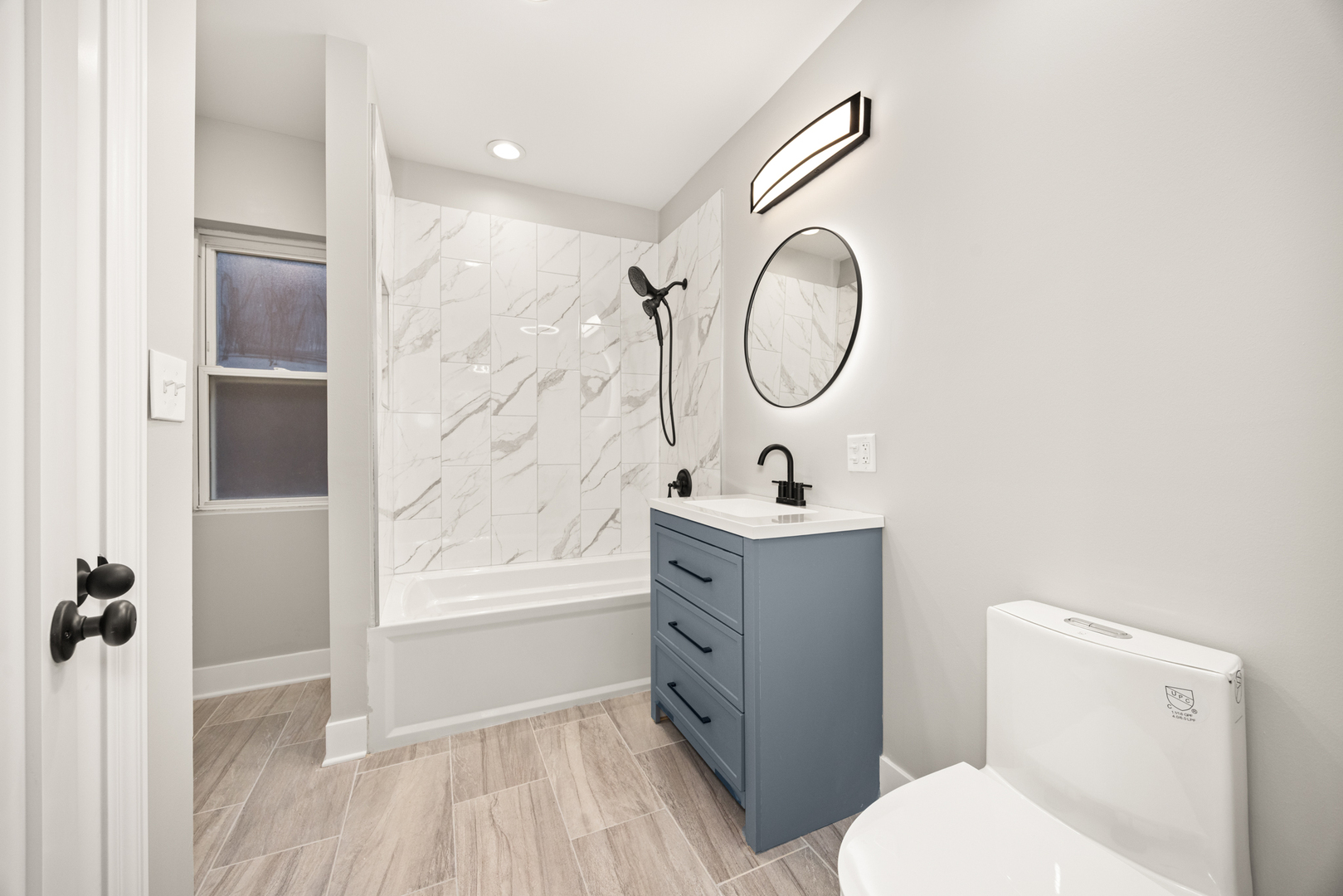 6748 South Indiana Avenue Chicago, IL 60637 - Photo 7 of 19 a bathroom with a sink a toilet and a mirror