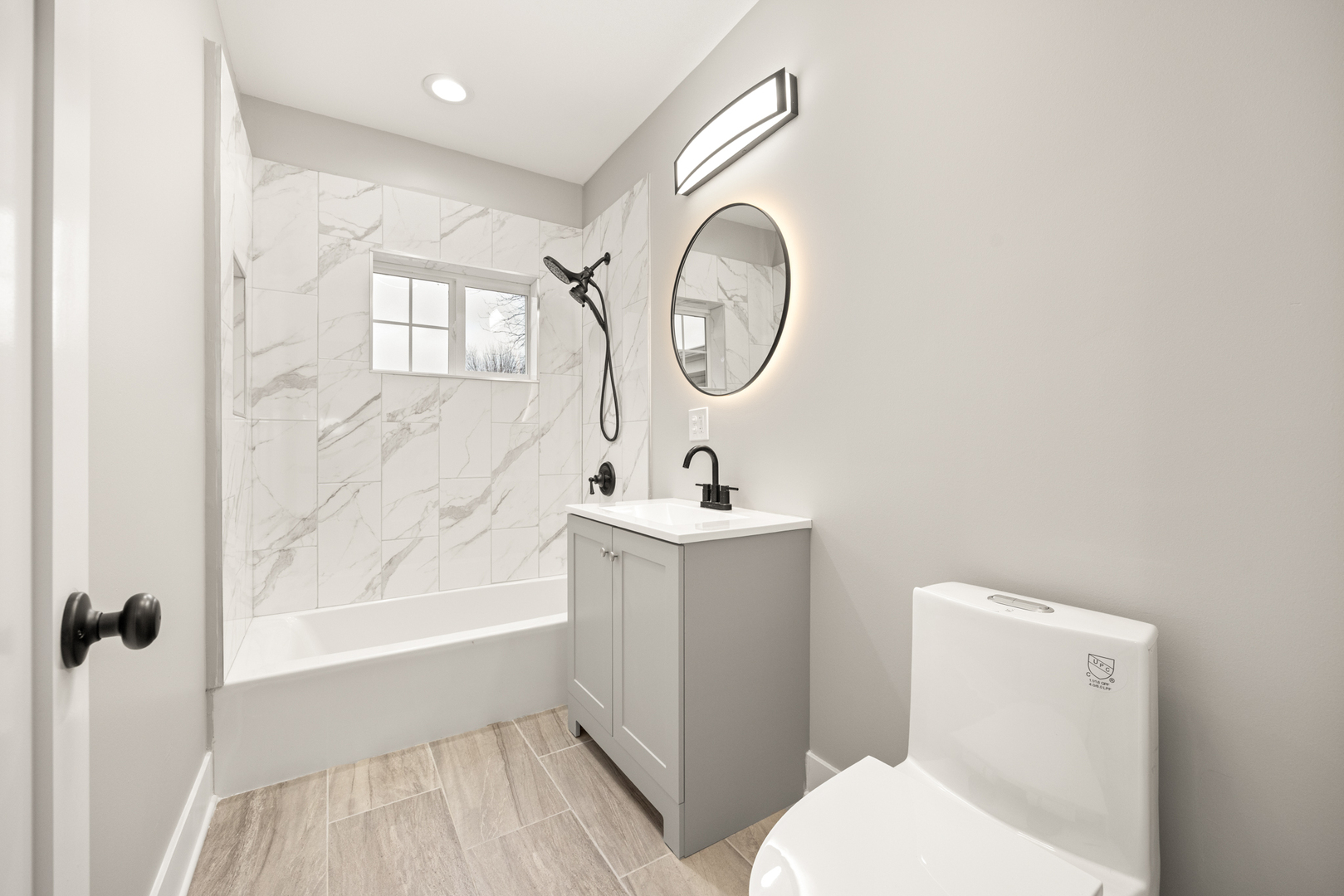 6748 South Indiana Avenue Chicago, IL 60637 - Photo 9 of 19 a bathroom with a sink a toilet and a mirror