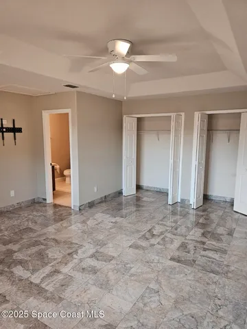 a view of a patio with a table chairs and a floor to ceiling window