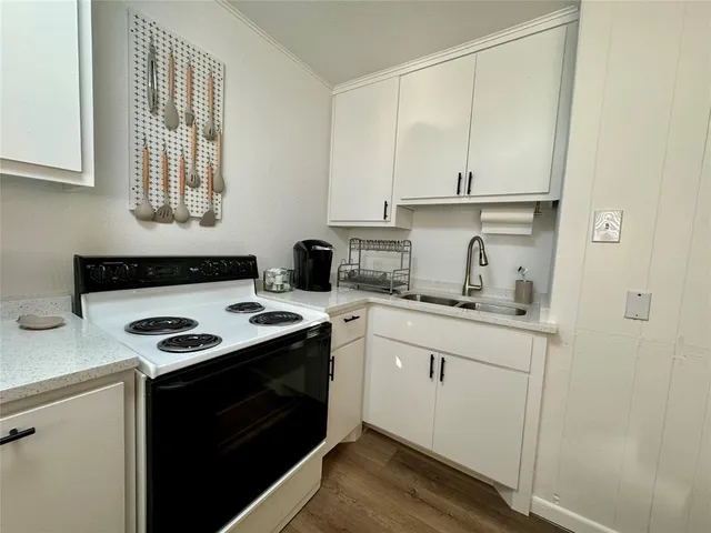 a kitchen with a sink stove and cabinets