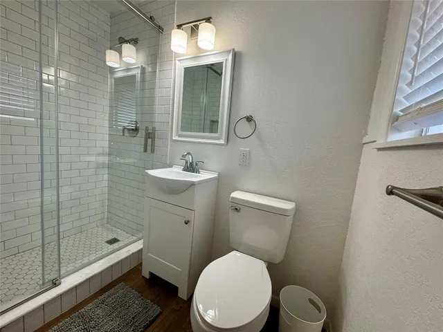 a bathroom with a toilet a sink and shower