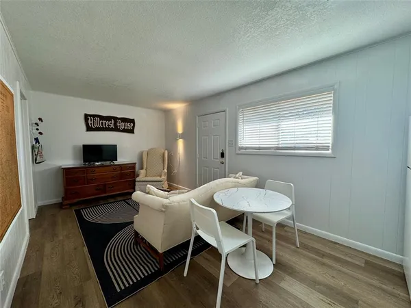 a living room with furniture a window and a table