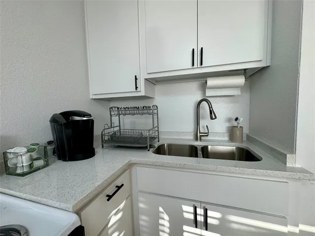 a kitchen with a sink and cabinets