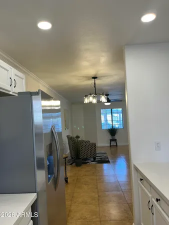 a living room with a table and a ceiling fan