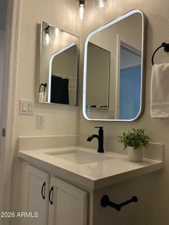 a bathroom with a sink and mirror