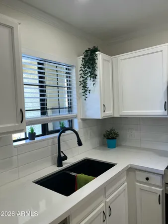 a kitchen with stainless steel appliances granite countertop a sink and a stove