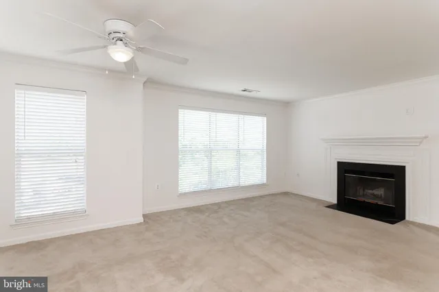 a view of empty room with a fireplace