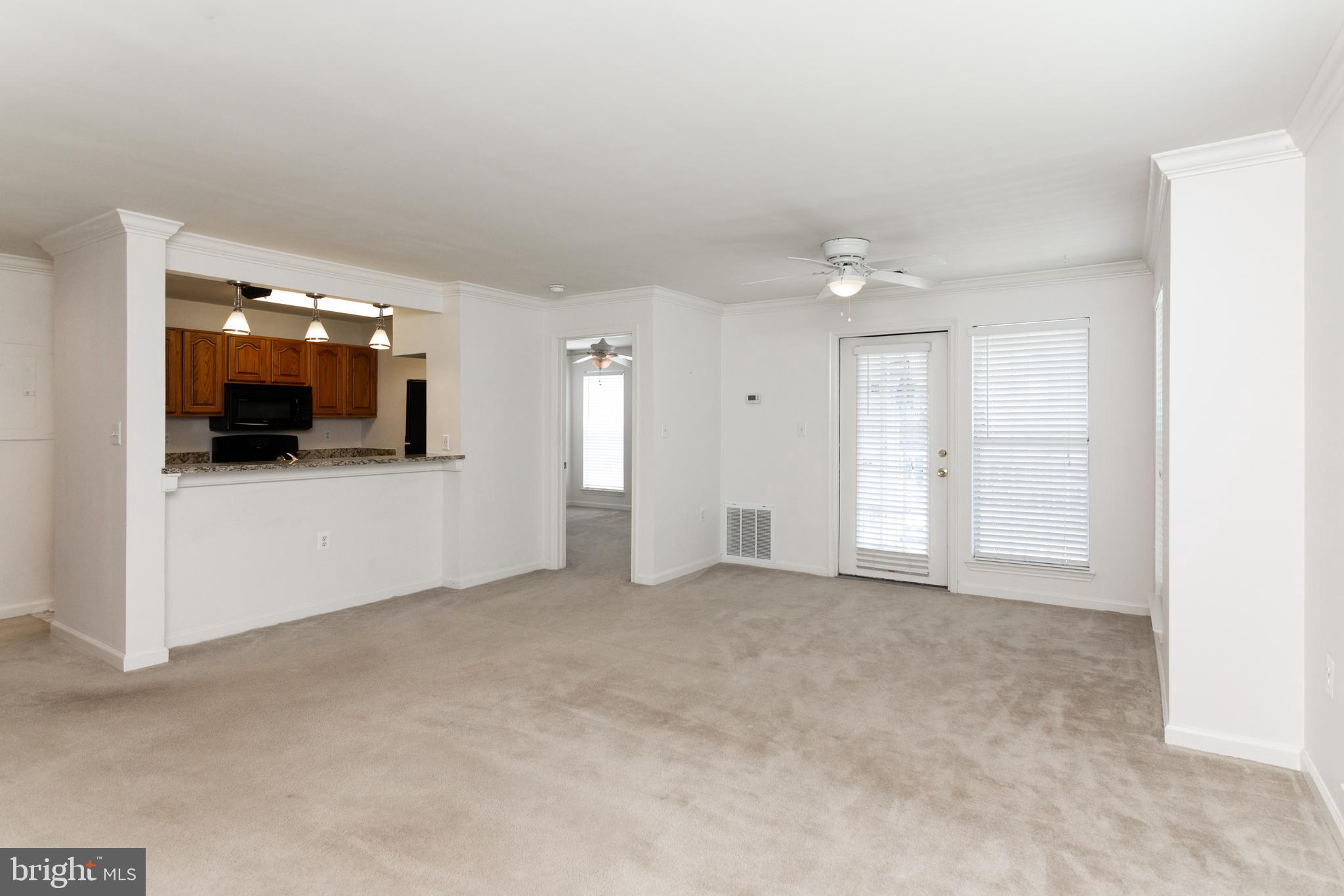 20958 Timber Ridge Terrace, Unit 201 Ashburn, VA 20147 - Photo 17 of 25 an empty room with furniture and flat screen tv
