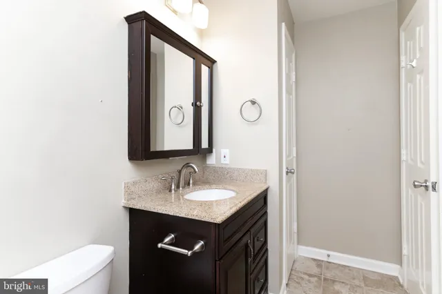 a bathroom with a sink vanity and a mirror