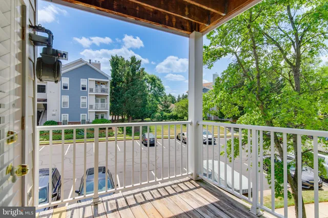 a view of a balcony with wooden floor