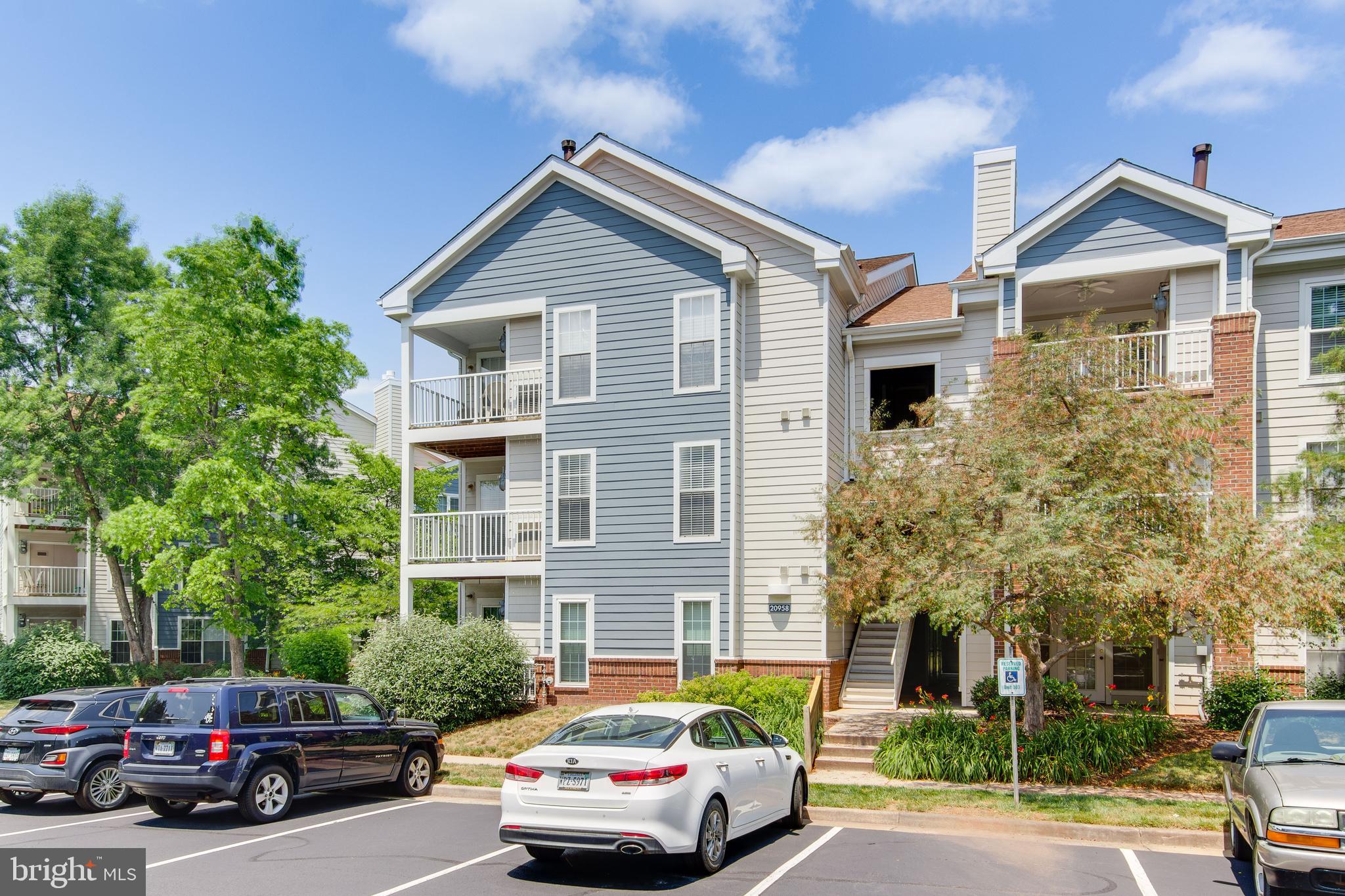 20958 Timber Ridge Terrace, Unit 201 Ashburn, VA 20147 - Photo 3 of 25 a car parked in front of a house