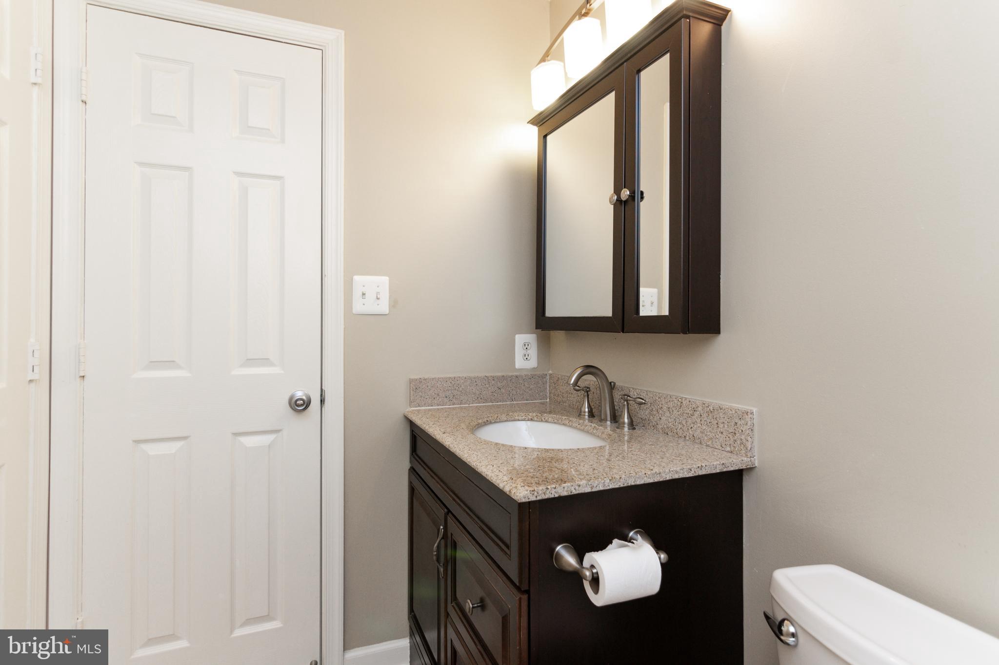 20958 Timber Ridge Terrace, Unit 201 Ashburn, VA 20147 - Photo 7 of 25 a bathroom with a sink and a mirror