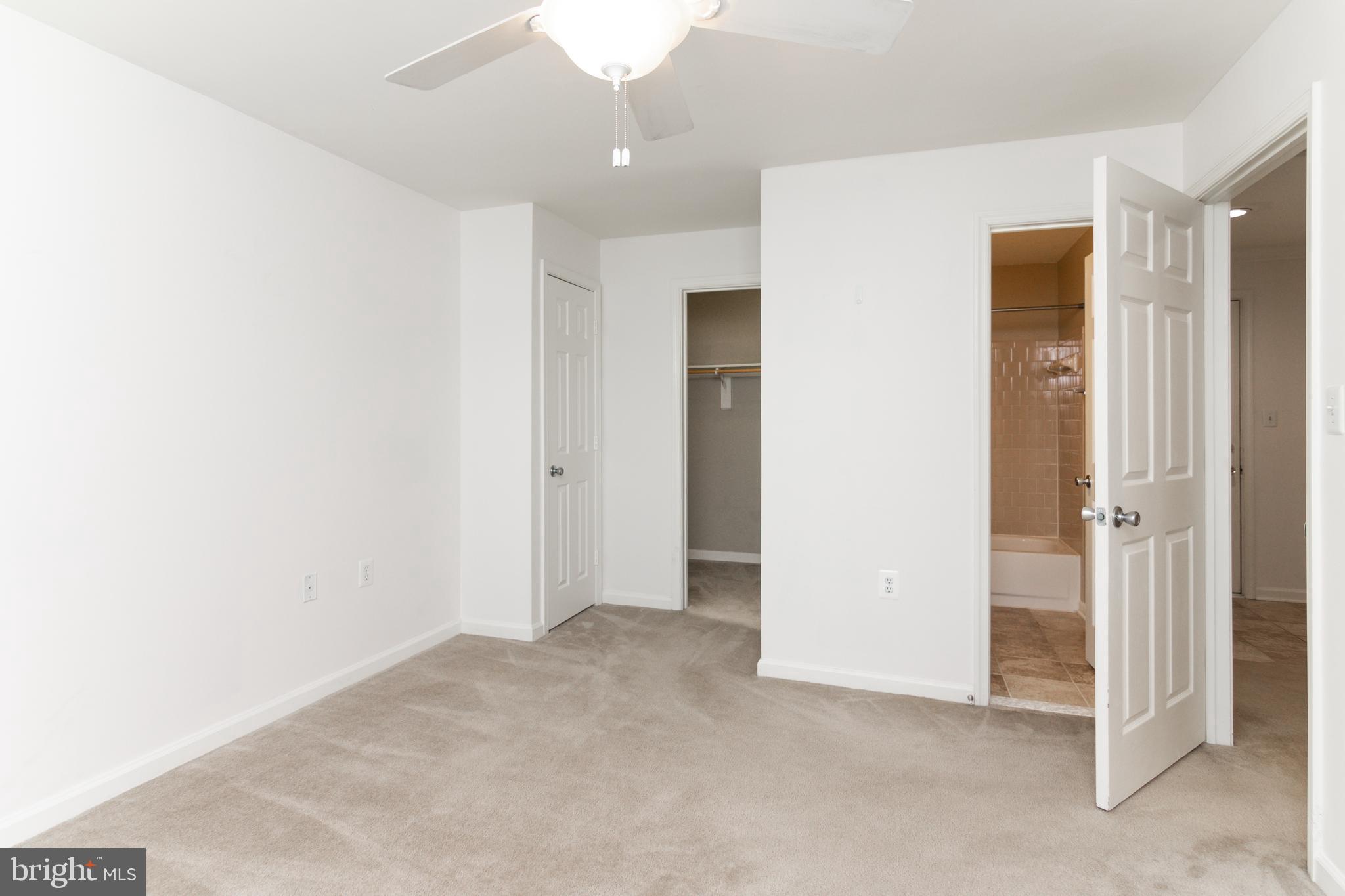 20958 Timber Ridge Terrace, Unit 201 Ashburn, VA 20147 - Photo 10 of 25 an empty room with a bathroom