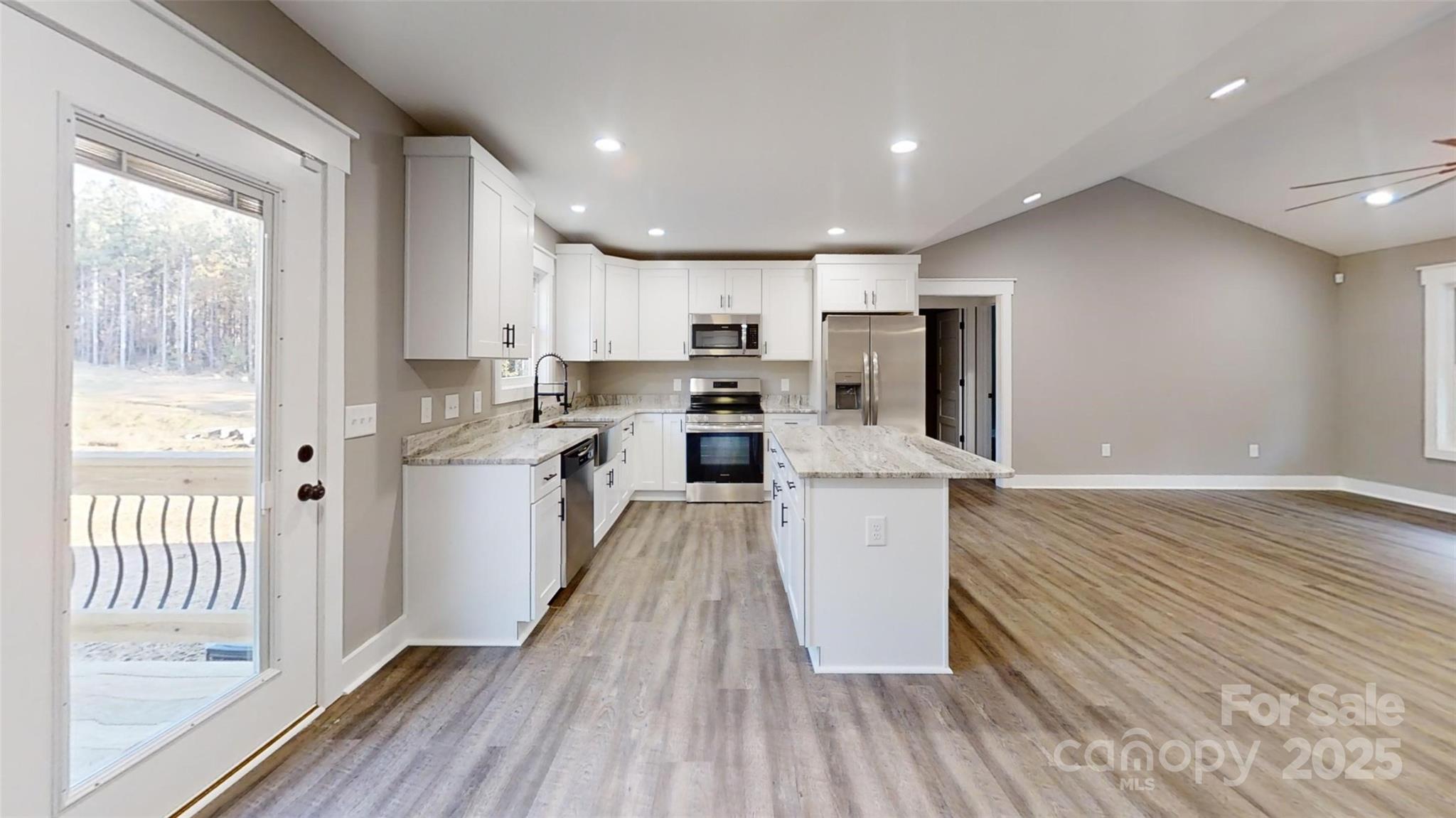 268 Vic Randall Road Lawndale, NC 28090 - Photo 15 of 22 a kitchen with kitchen island wooden floors appliances and cabinets