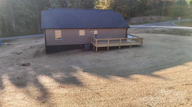 a backyard of a house with table and chairs