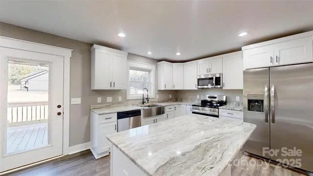 a kitchen with refrigerator cabinets and wooden floor