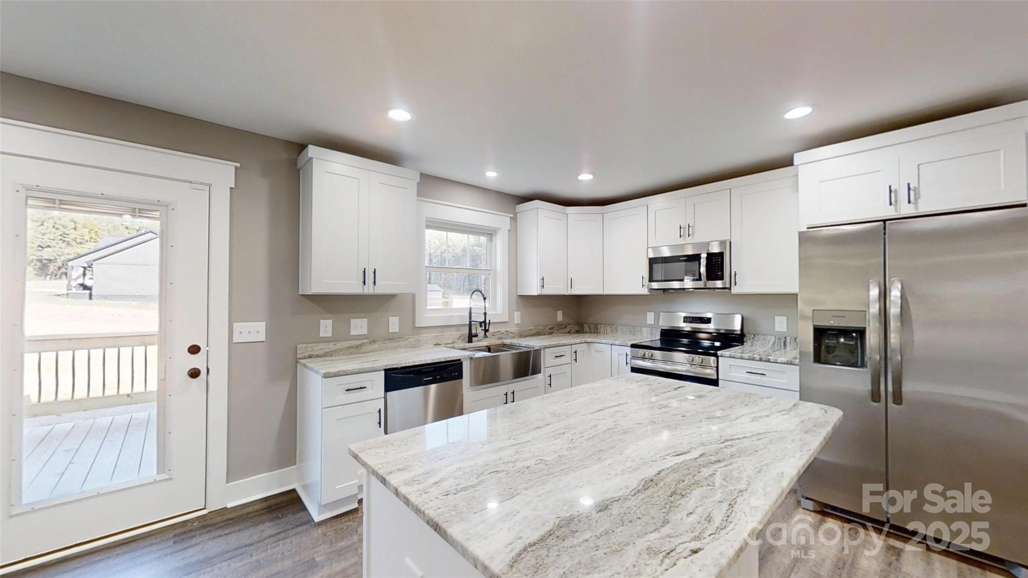 268 Vic Randall Road Lawndale, NC 28090 - Photo 2 of 22 a kitchen with refrigerator cabinets and wooden floor