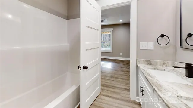 a bathroom with a bathtub and a sink