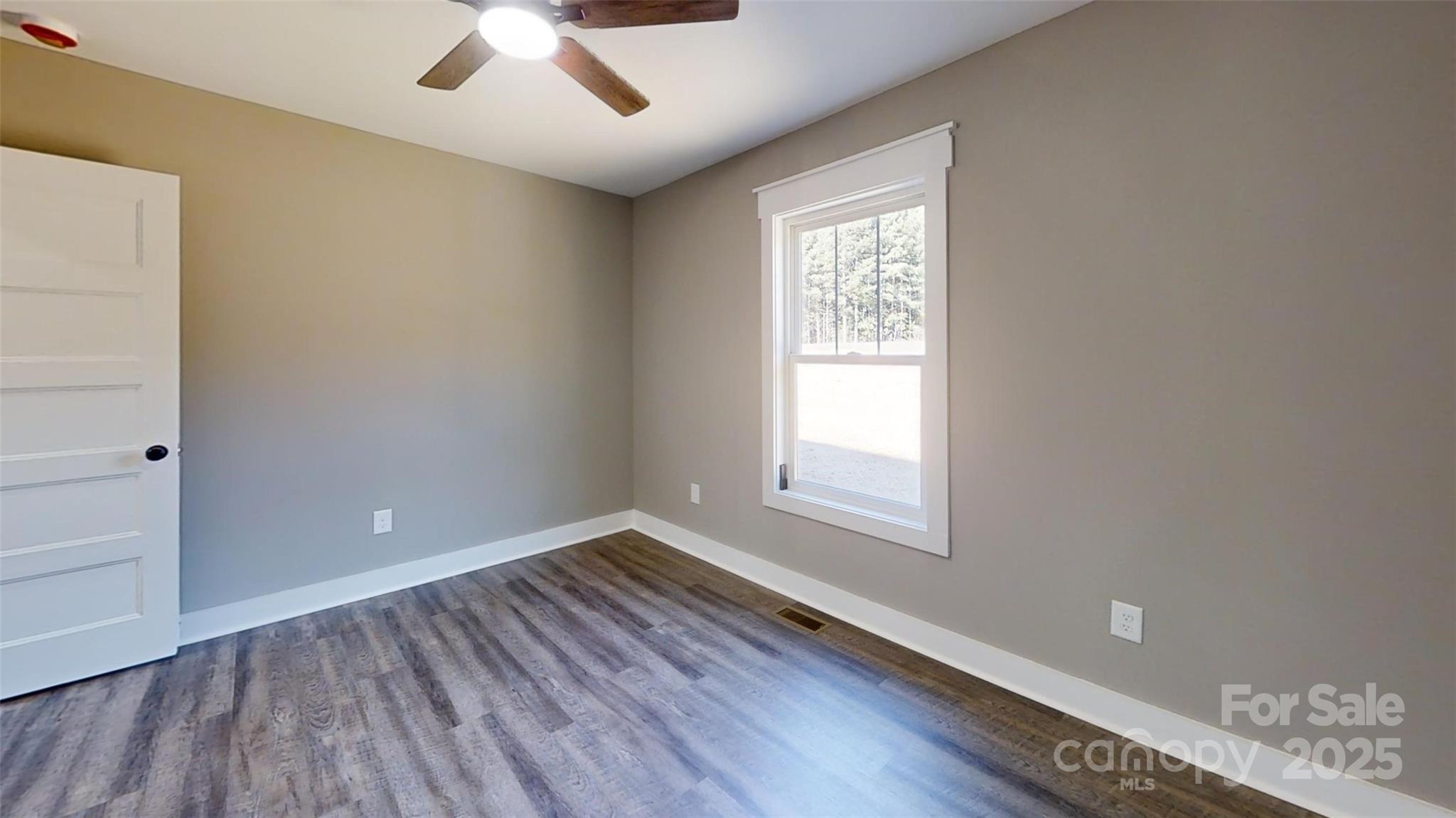 268 Vic Randall Road Lawndale, NC 28090 - Photo 9 of 22 wooden floor in an empty room with a window