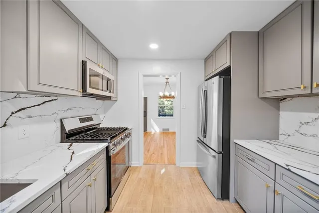 a kitchen with stainless steel appliances a refrigerator a stove a microwave and cabinets