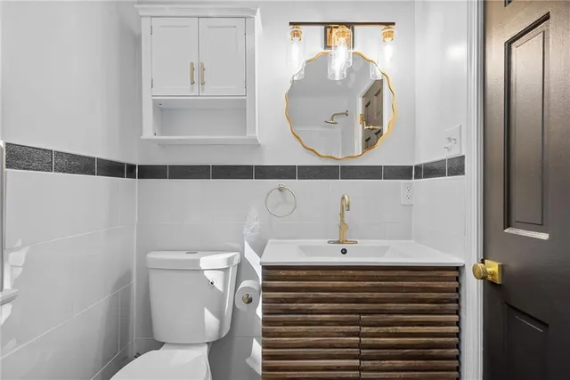 a bathroom with a sink a toilet and a mirror