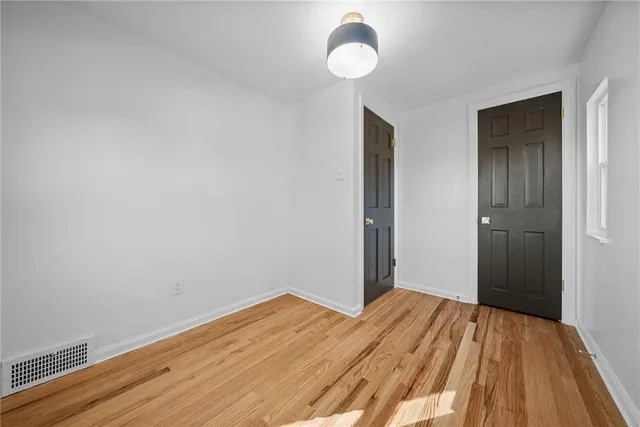 a view of a room with wooden floor and bathroom