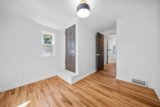 a view of a livingroom with wooden floor and window