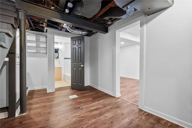 a view of hallway with wooden floor