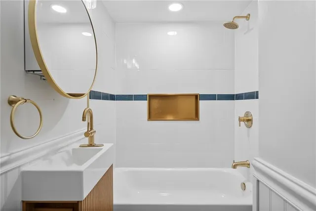 a bathroom with a sink a mirror and a shower